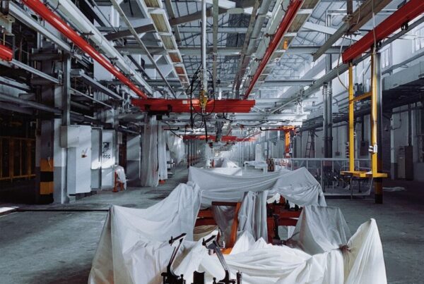 orange industrial machine covered with white textiles