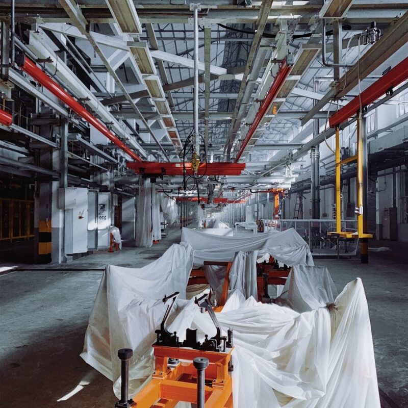 orange industrial machine covered with white textiles